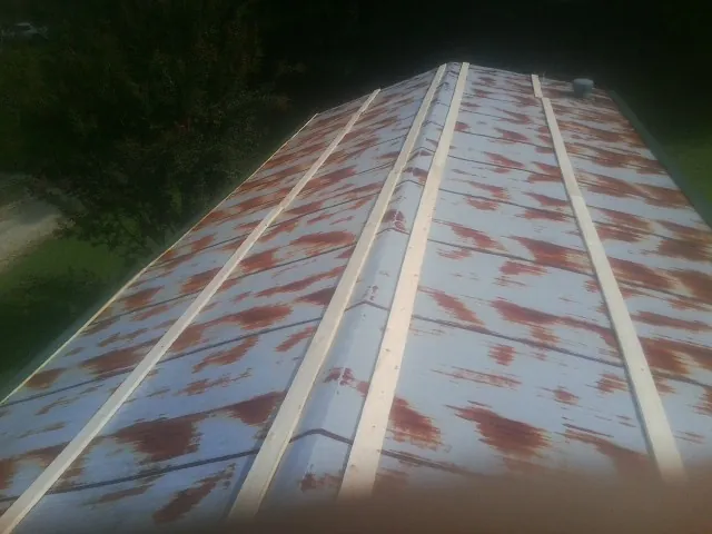 Rusted metal roof panels with new wood purlins before replacement — Storm Damage Roof Repair in Tow by Roofing Brothers